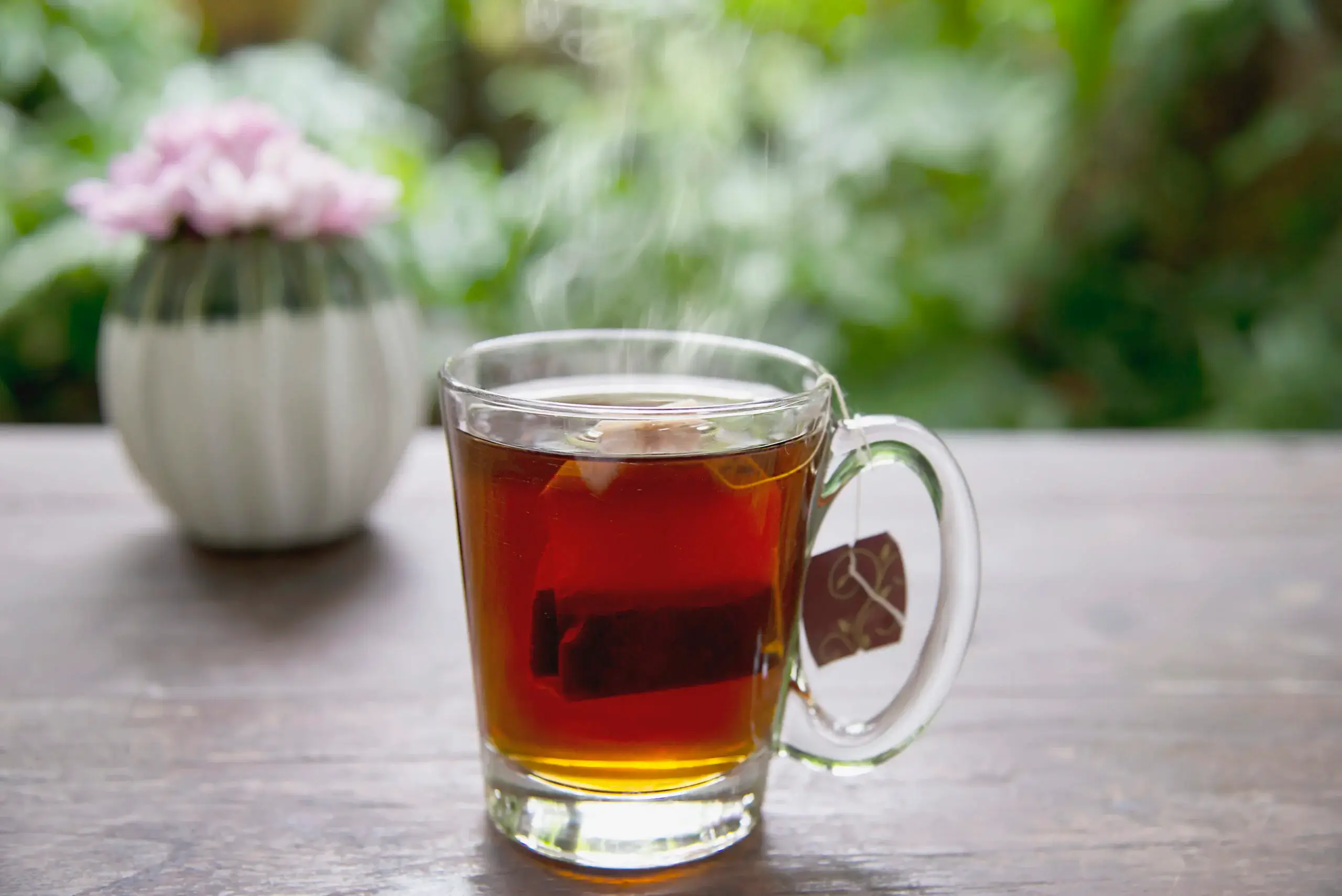 Hot cup of tea on table